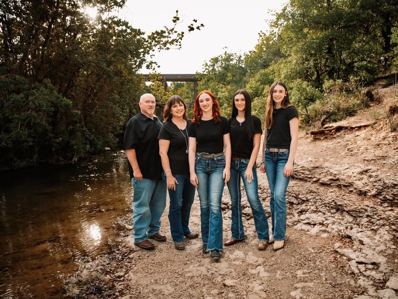 The Stain Guys team standing together on a creek bank in Georgetown