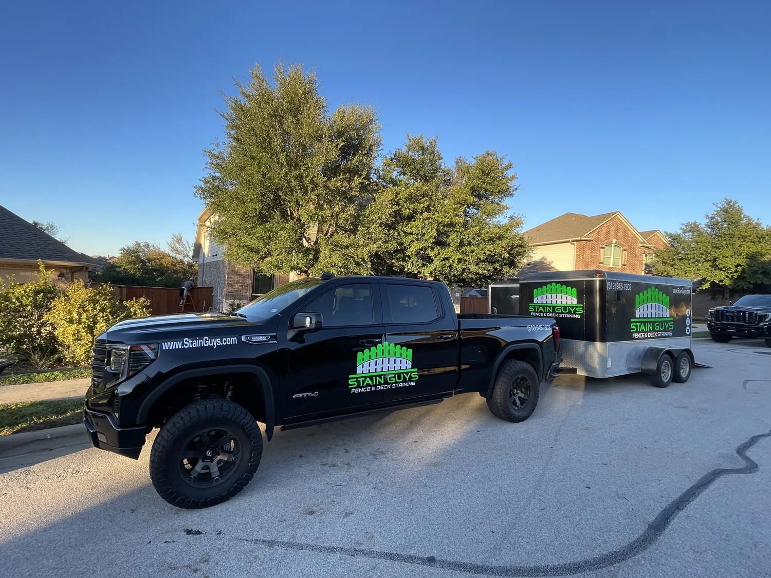The Stain Guys wrapped pickup and trailer parked on a Georgetown street