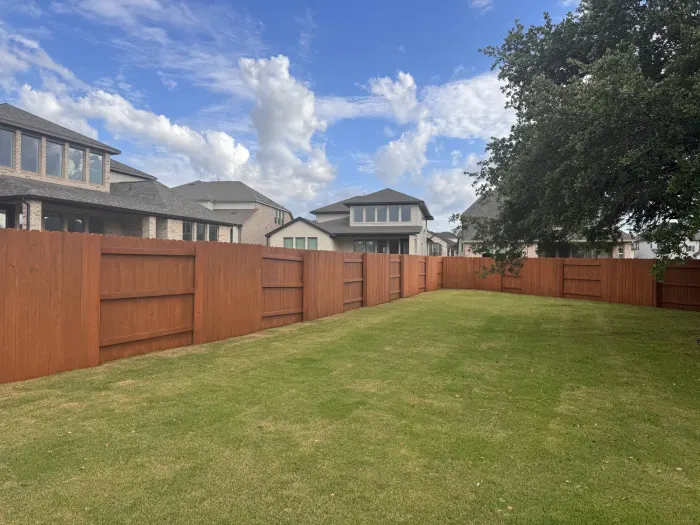 Signature Cedar stain on a backyard privacy fence stained by Stain Guys
