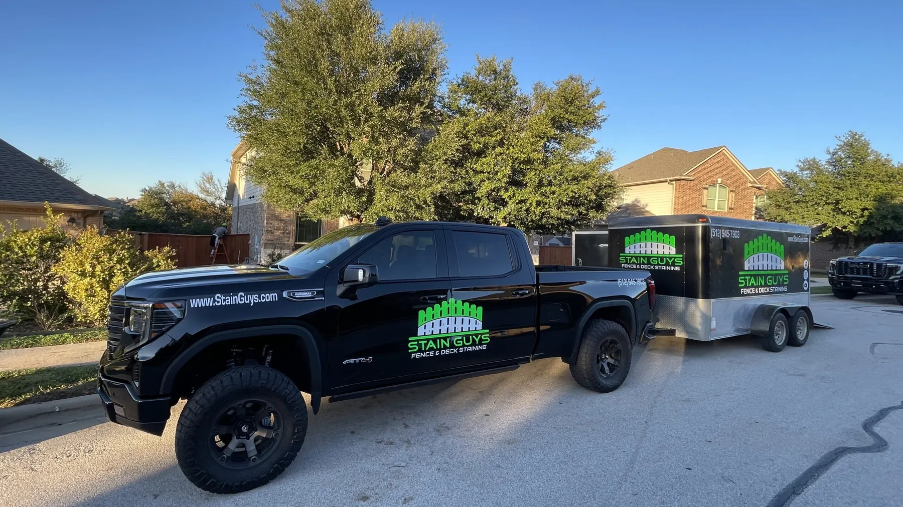 The Stain Guys truck and trailer parked in a Georgetown neighborhood